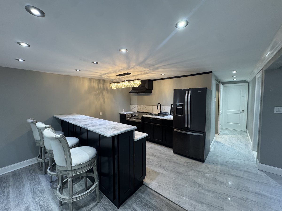 A finished basement kitchen and bar built by Ground Up Construction